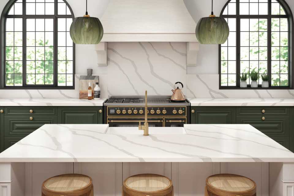 marble backsplash in kitchen with forest green accents and arched windows